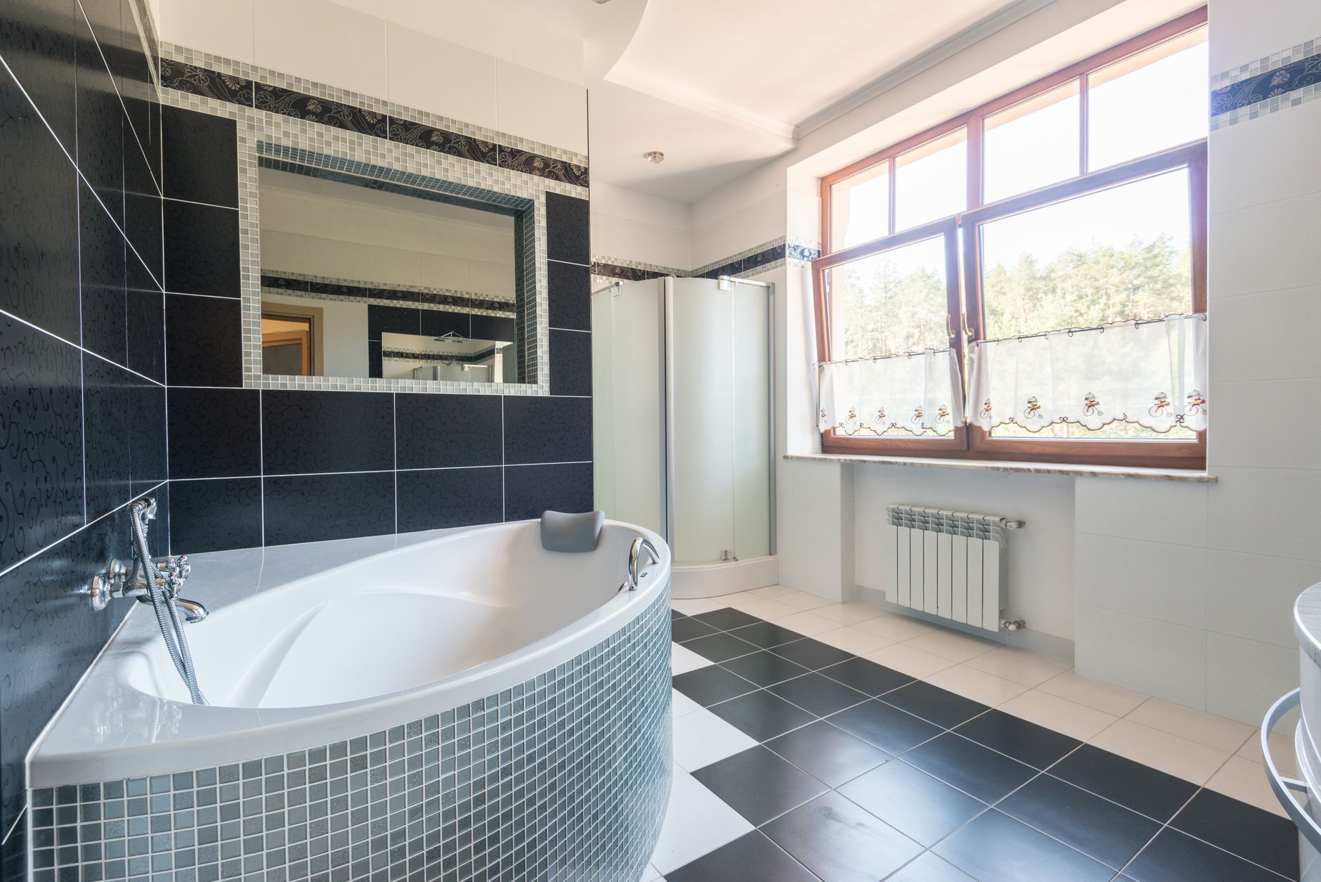 A tiled bathroom with a corner tub