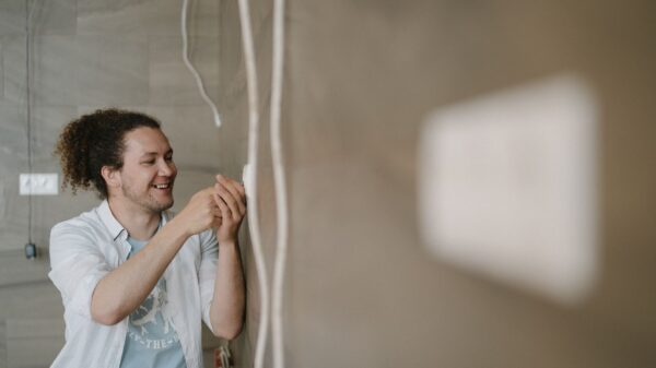 Best multimeter: a man checking a wall during an electrical project