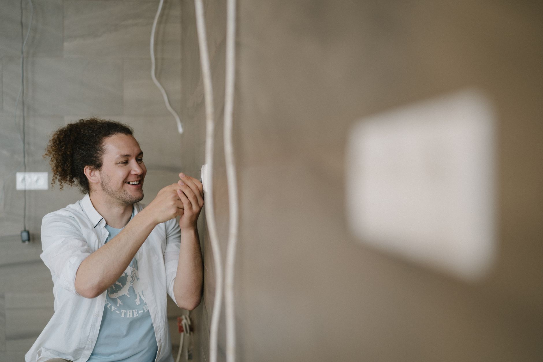 Best multimeter: a man checking a wall during an electrical project
