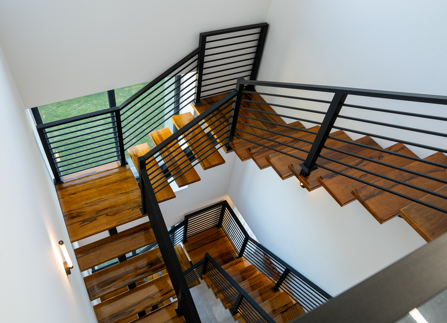 A wood and metal staircase seen from above
