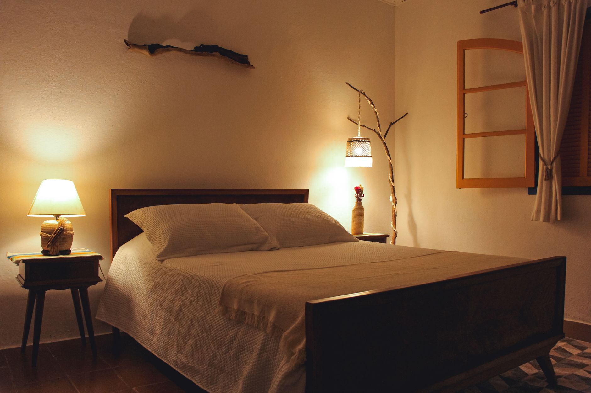 A bedroom lit by warm bedside lamps