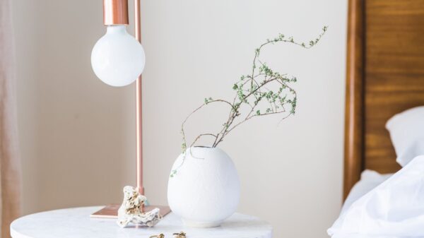 Best nightstand: a bedside table with a lamp next to a made bed
