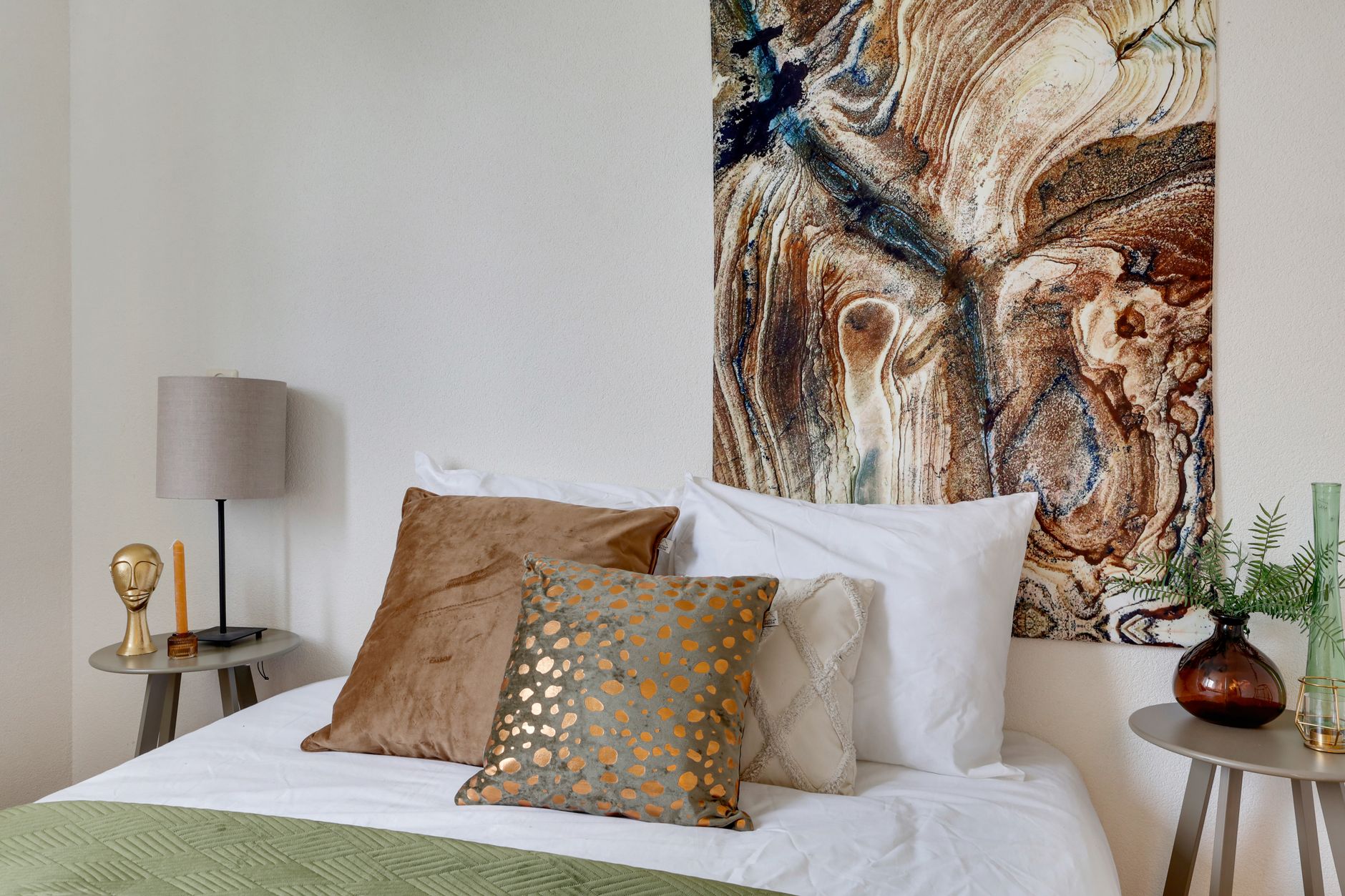A nightstand beside a bed in a bedroom