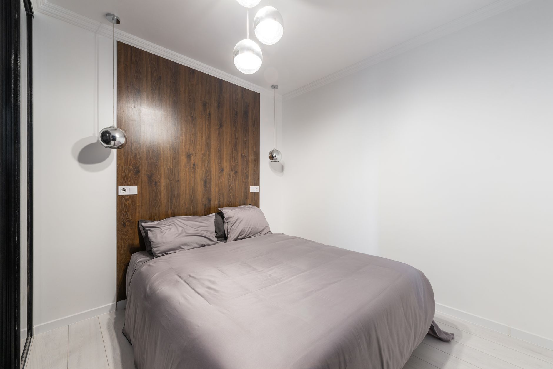 A compact bedroom with a small table next to the bed
