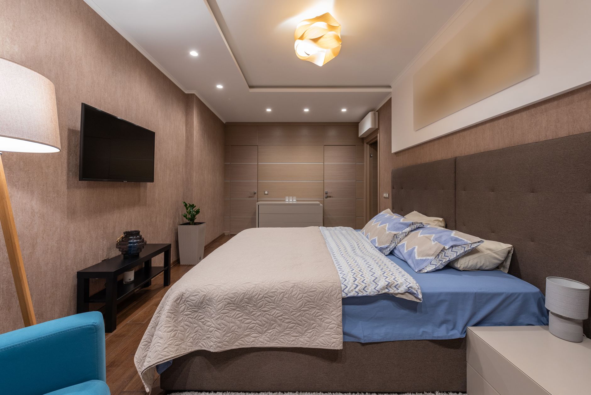 Modern bedroom furniture arranged around a bed