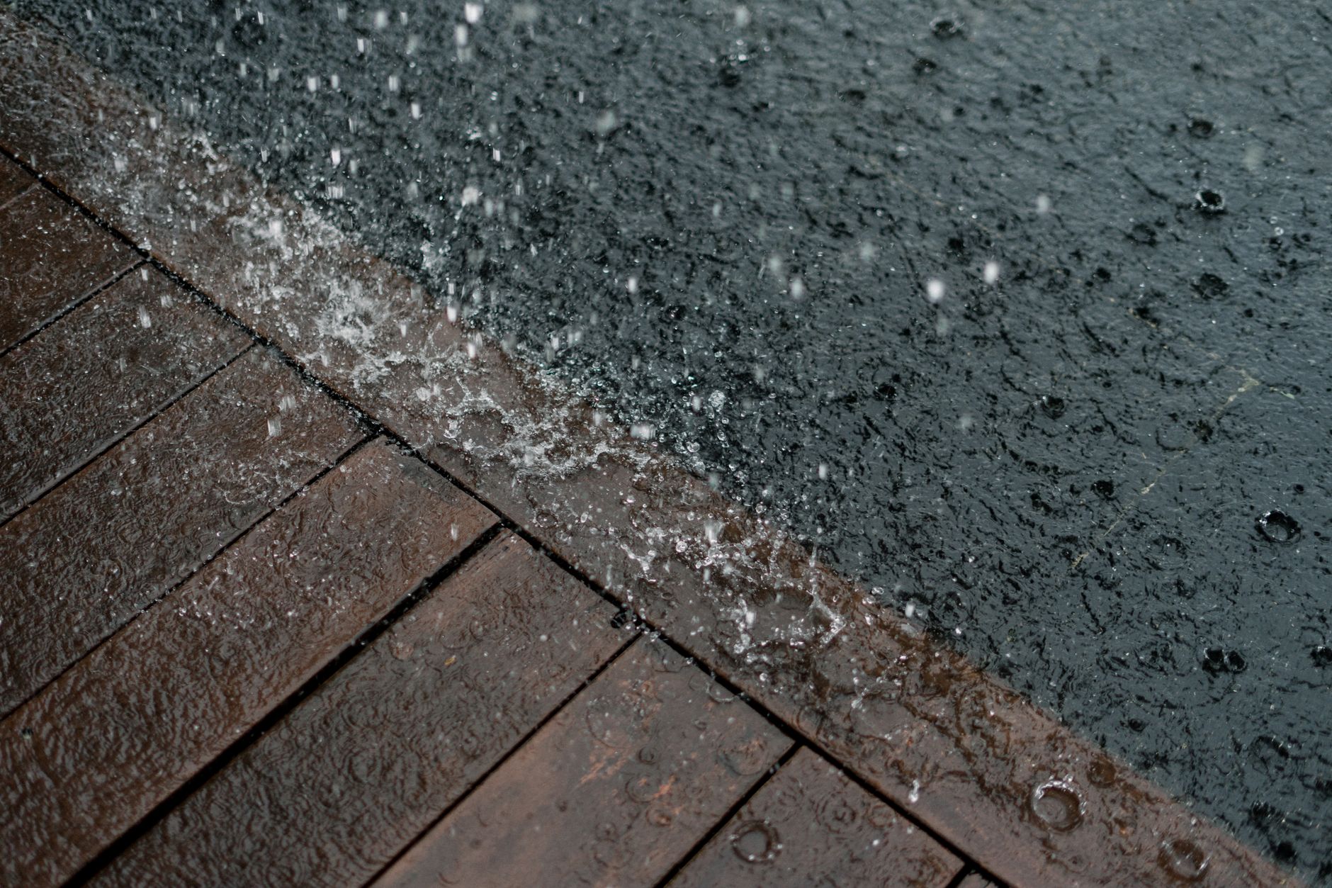 Rain falling on a wooden deck