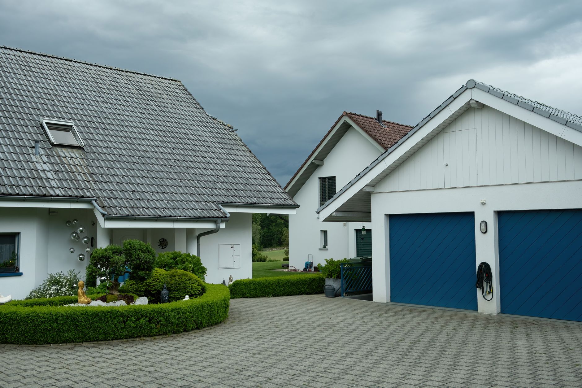 A white house with a paved driveway