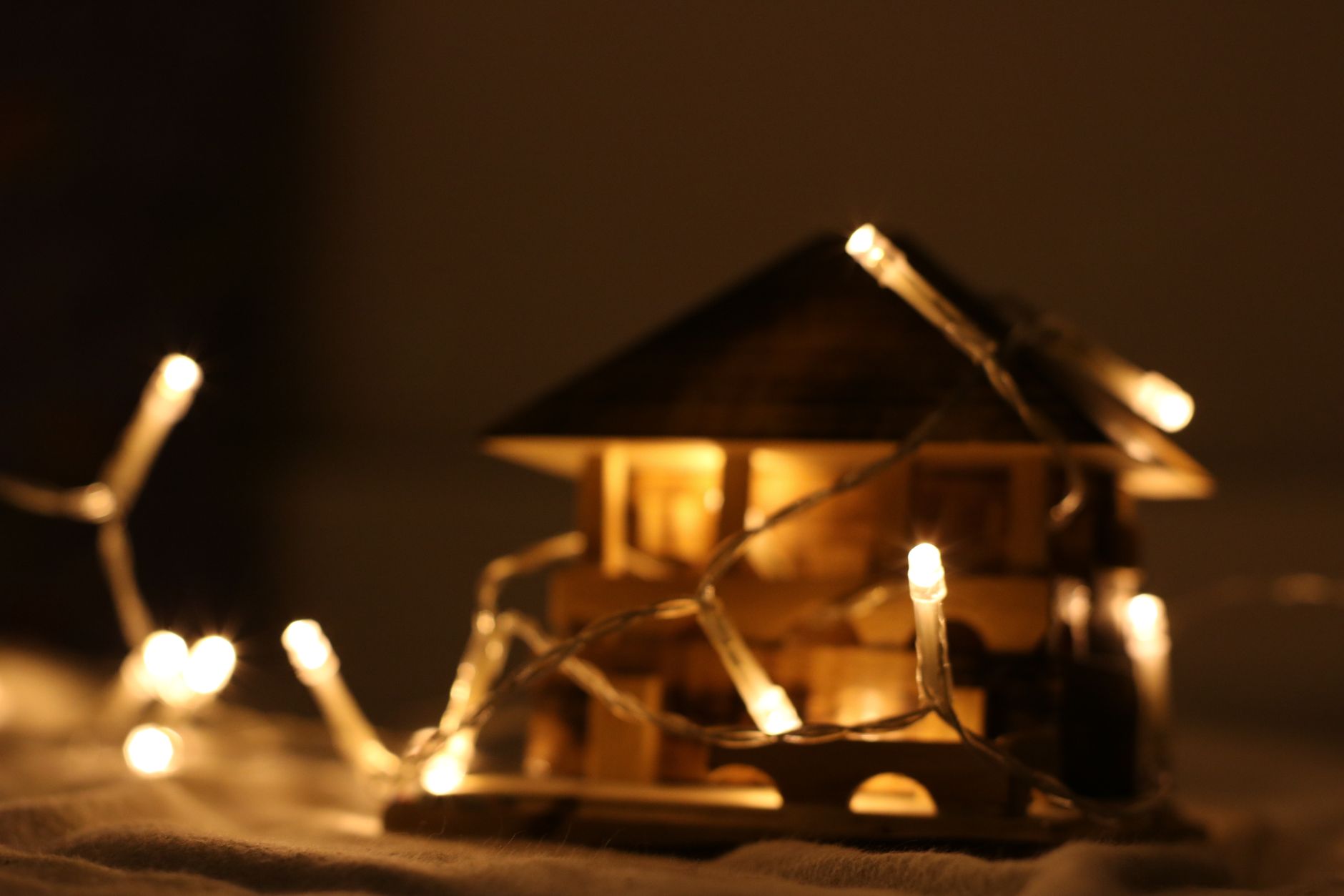 Best outdoor timer for lights: a model house wrapped in string lights