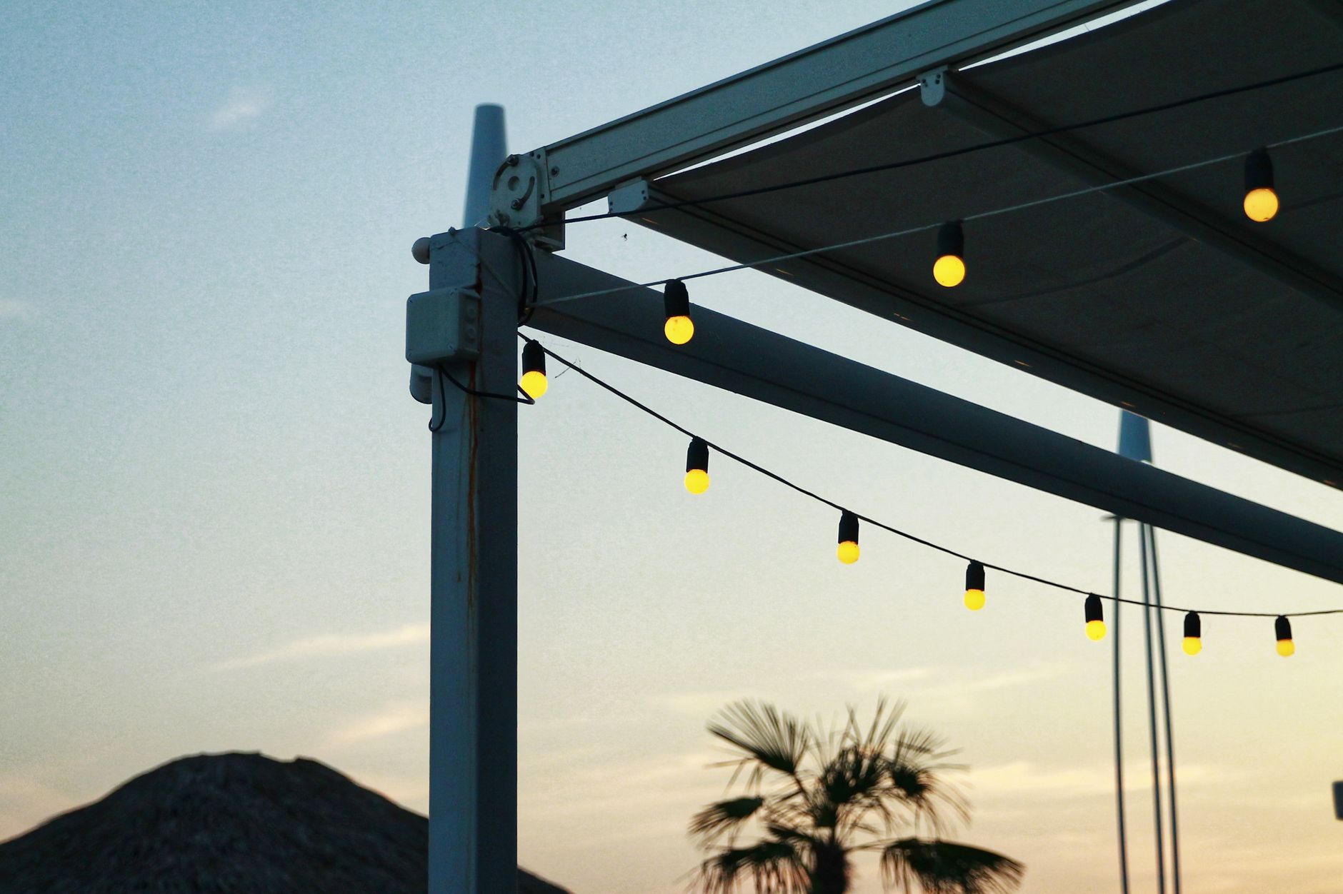 String lights on a patio frame at dusk