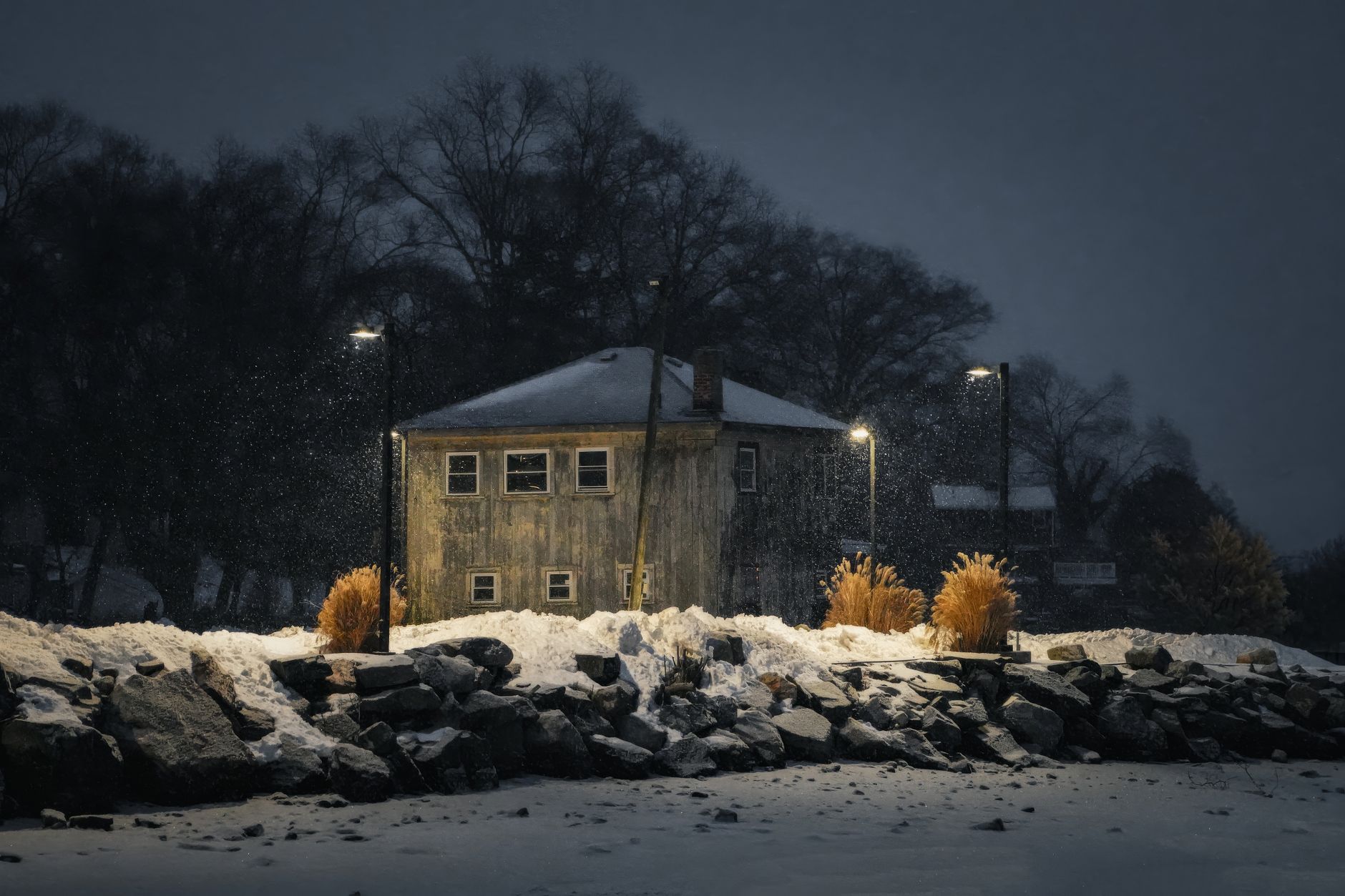 A house lit at night in the snow