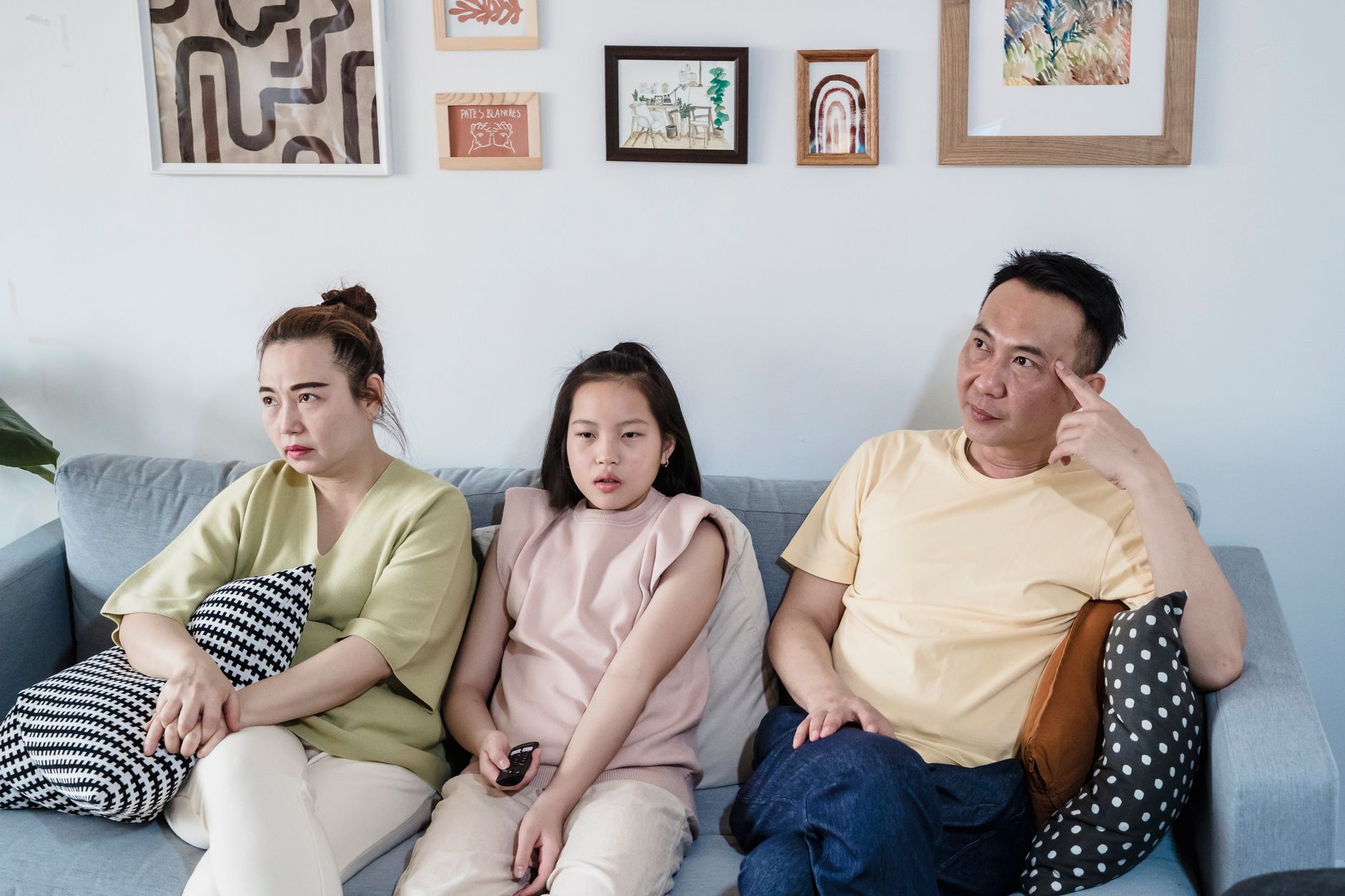 A family sitting together on a living room sofa
