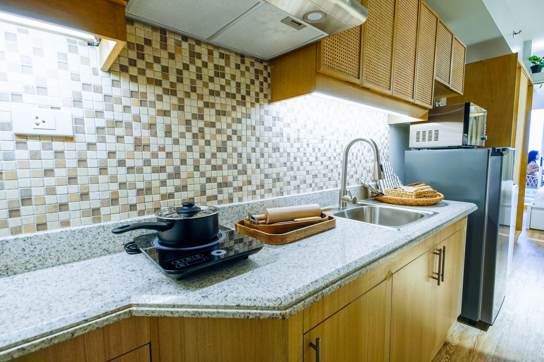 A kitchen counter with a wall outlet above it