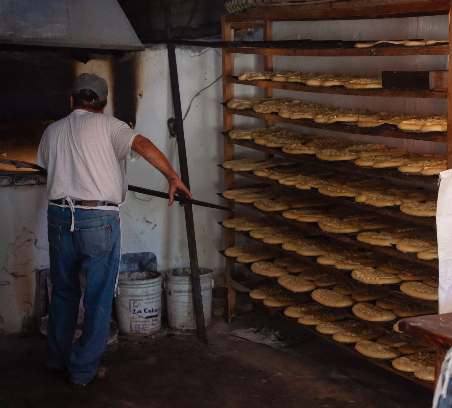 A baker at a wood-fired bread oven