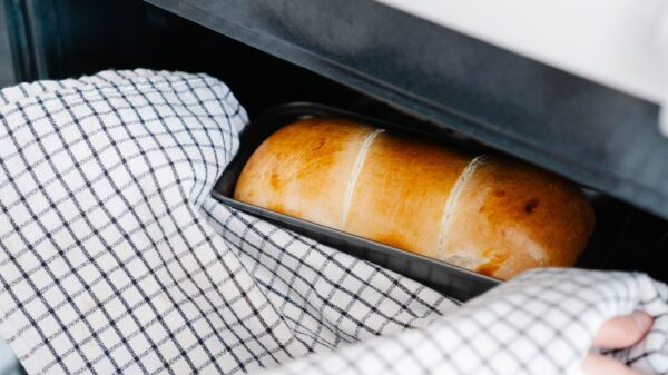 Best oven mitts: taking a loaf from the oven with a towel