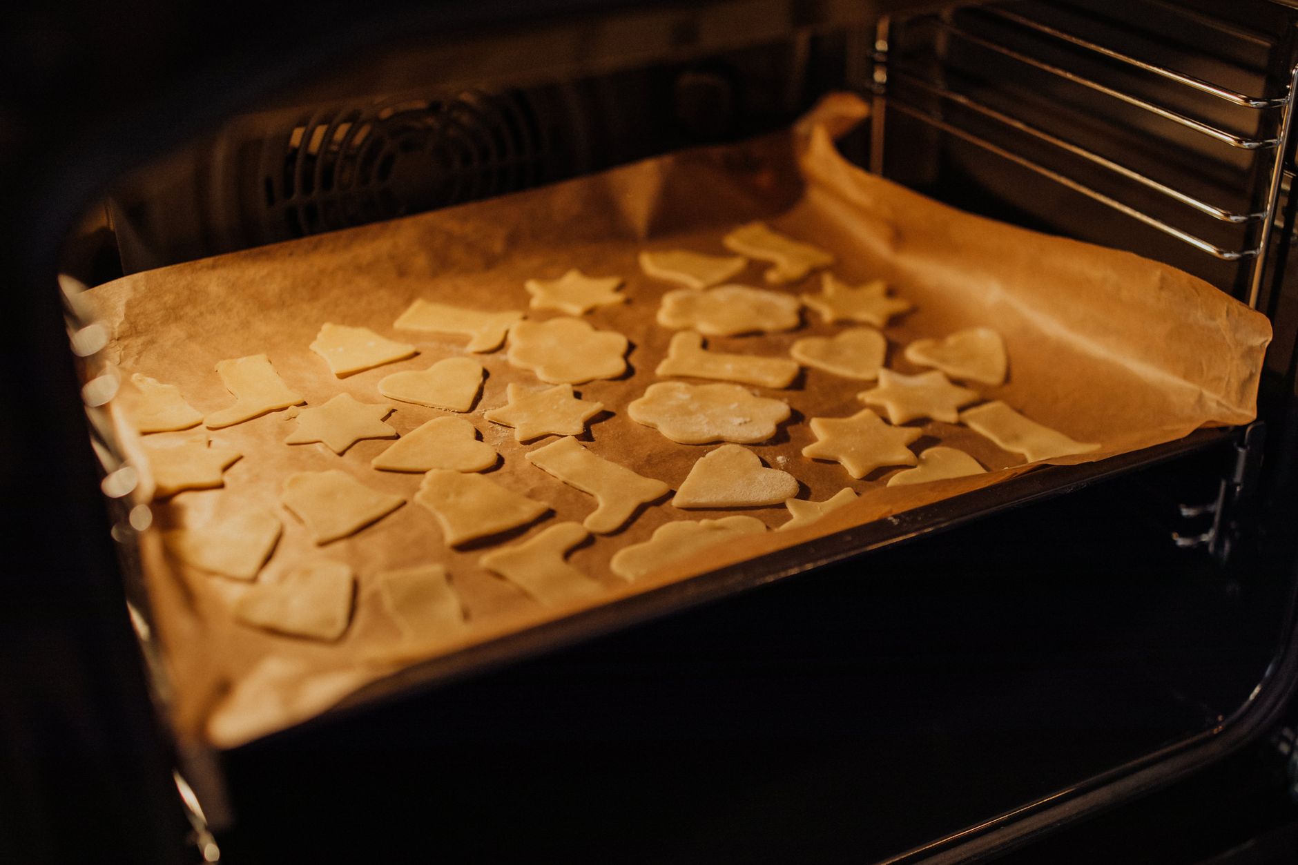 Cut-out cookies on a baking sheet in the oven