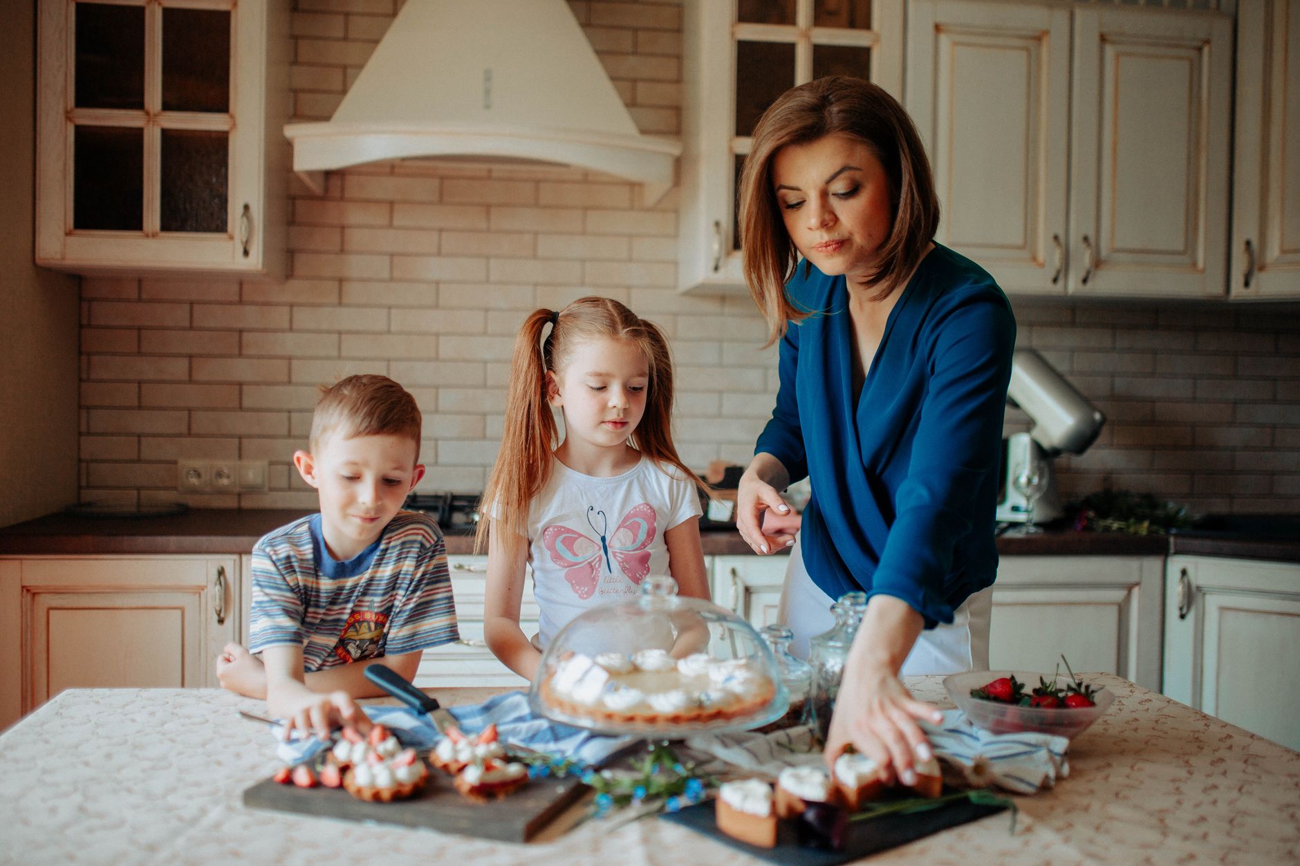 A mother and children baking in a kitchen