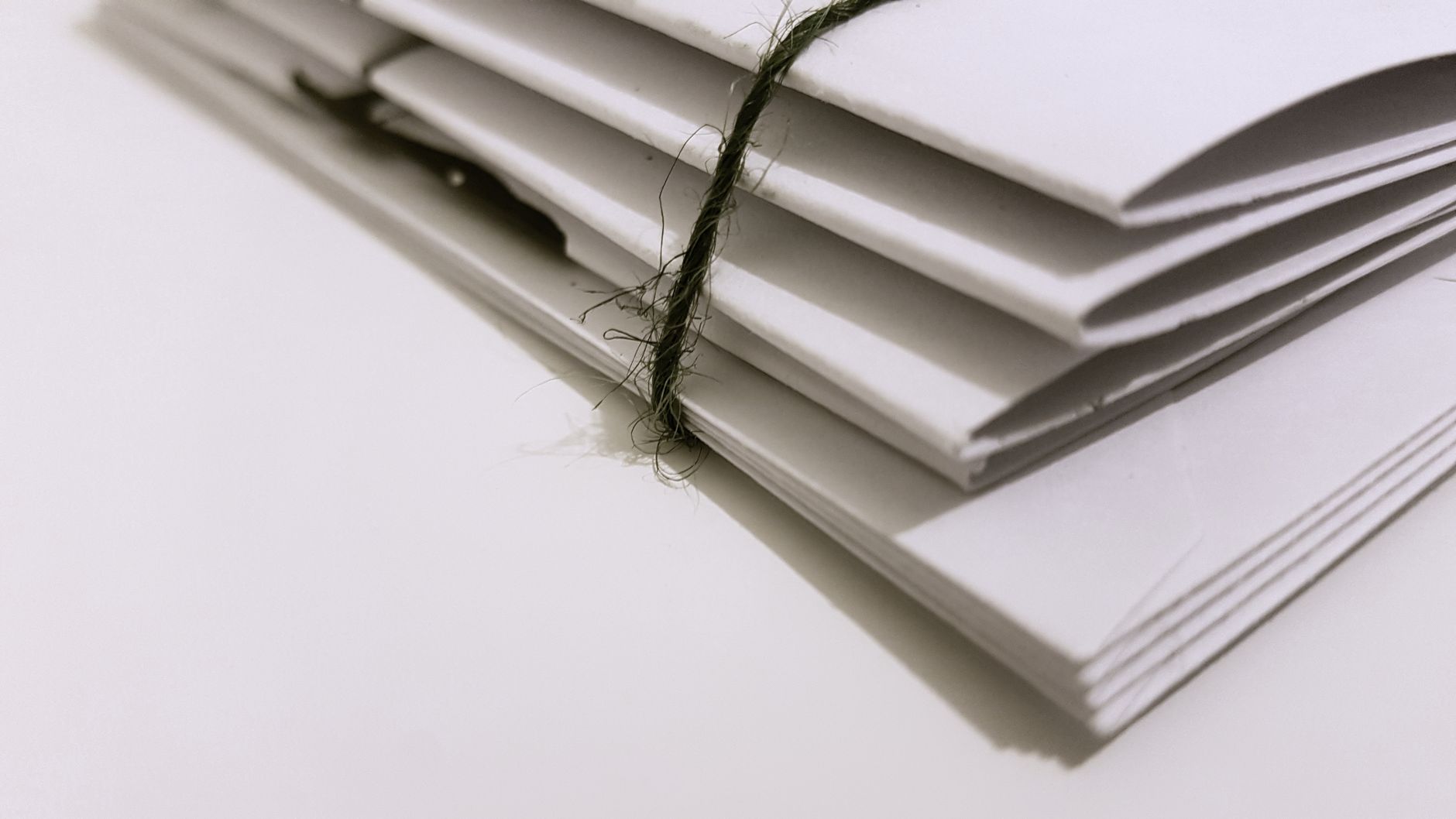 A tied stack of paper documents