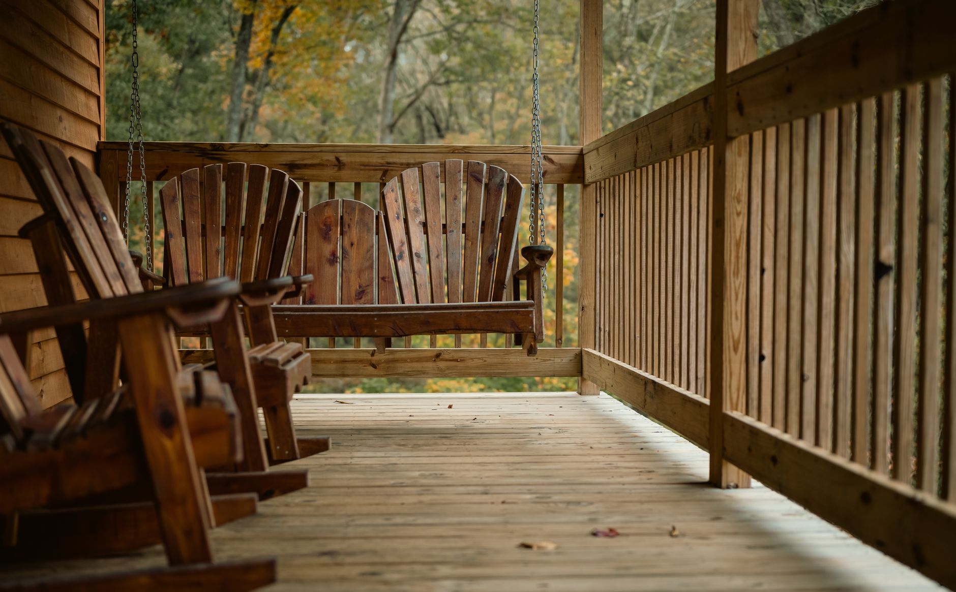 Rocking chairs and a porch swing on a covered porch