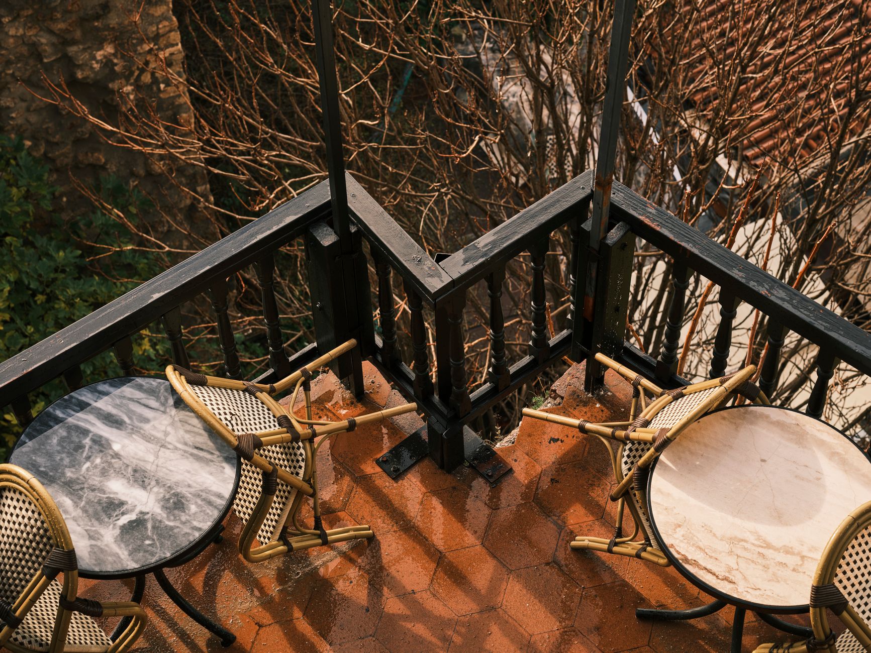 Two chairs and small tables on a balcony