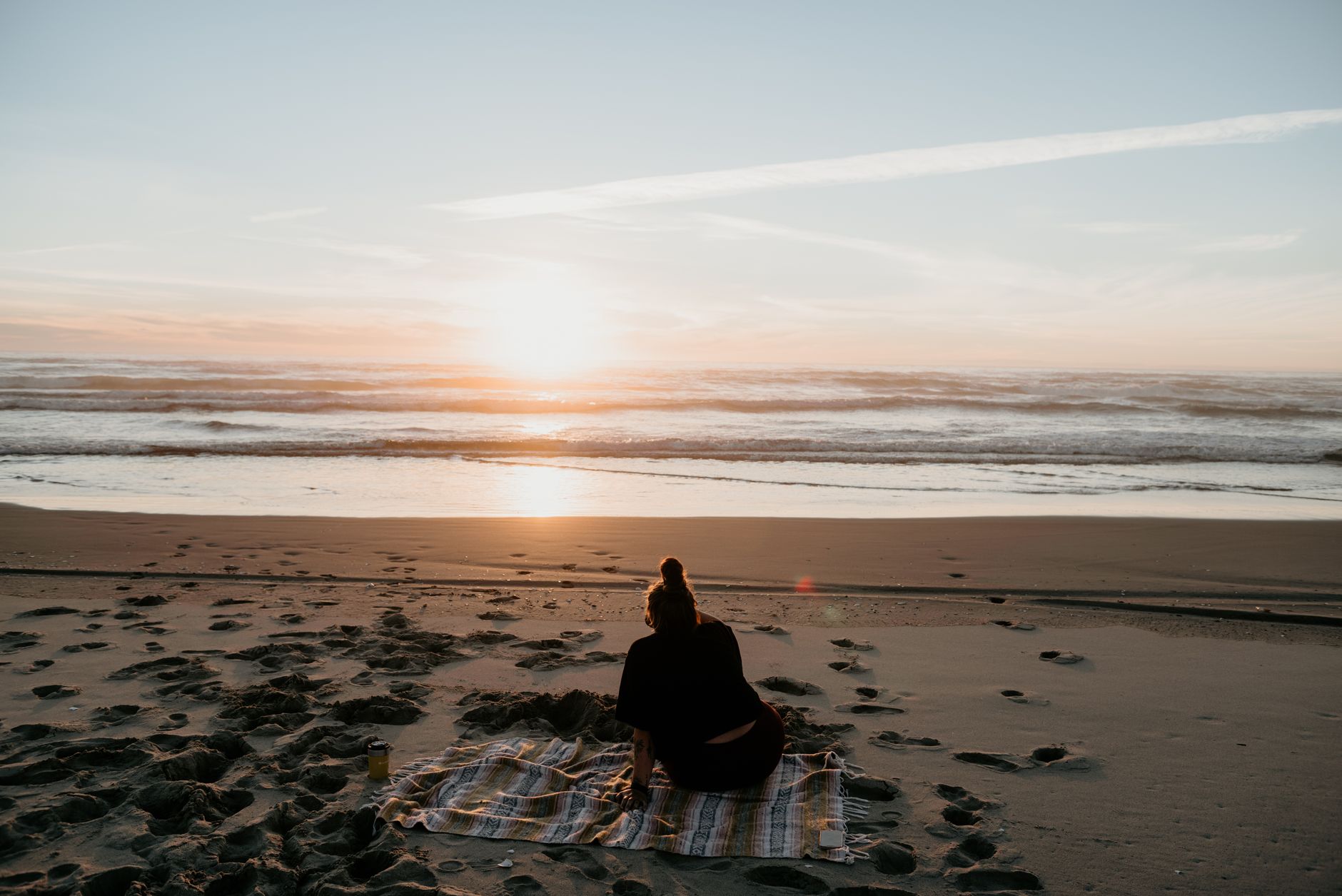 A blanket laid out on a sandy beach