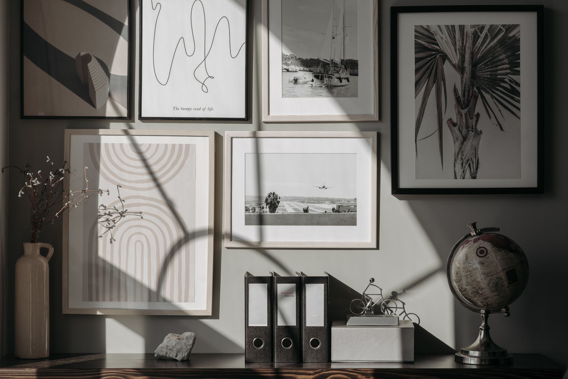A gallery wall of framed pictures in a living room