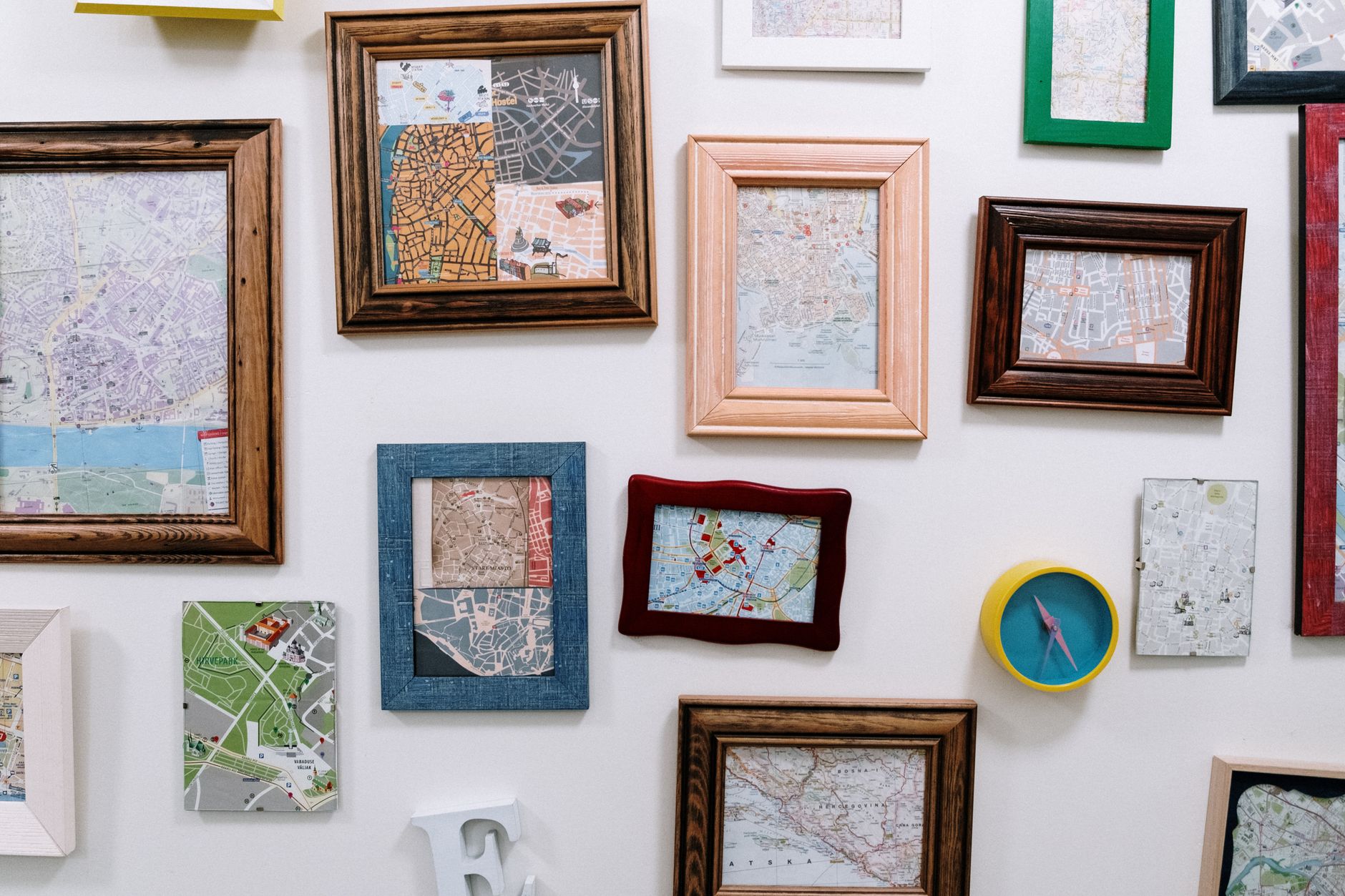 A group of framed pictures arranged on a living room wall