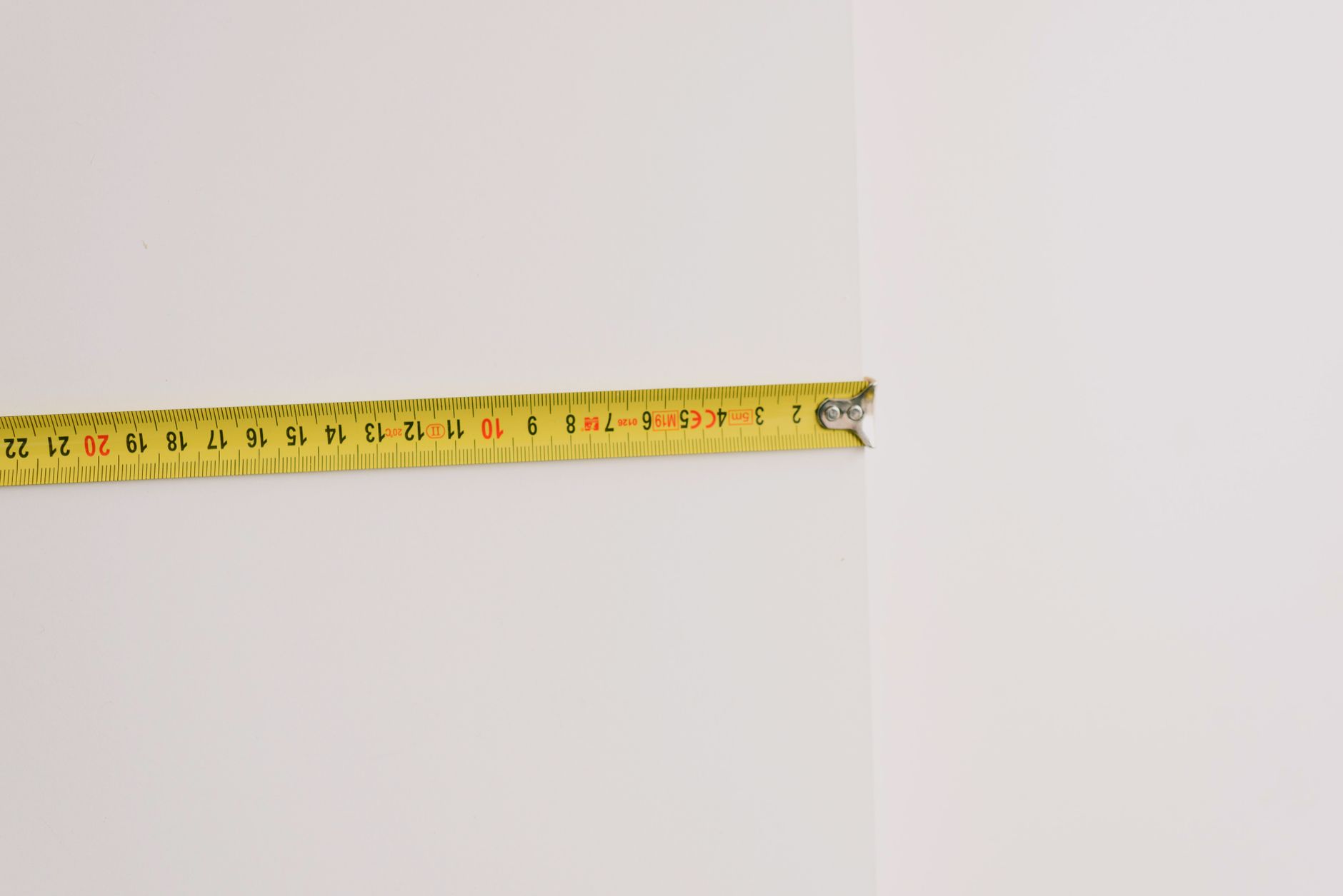 A tape measure used to mark a spot on a wall