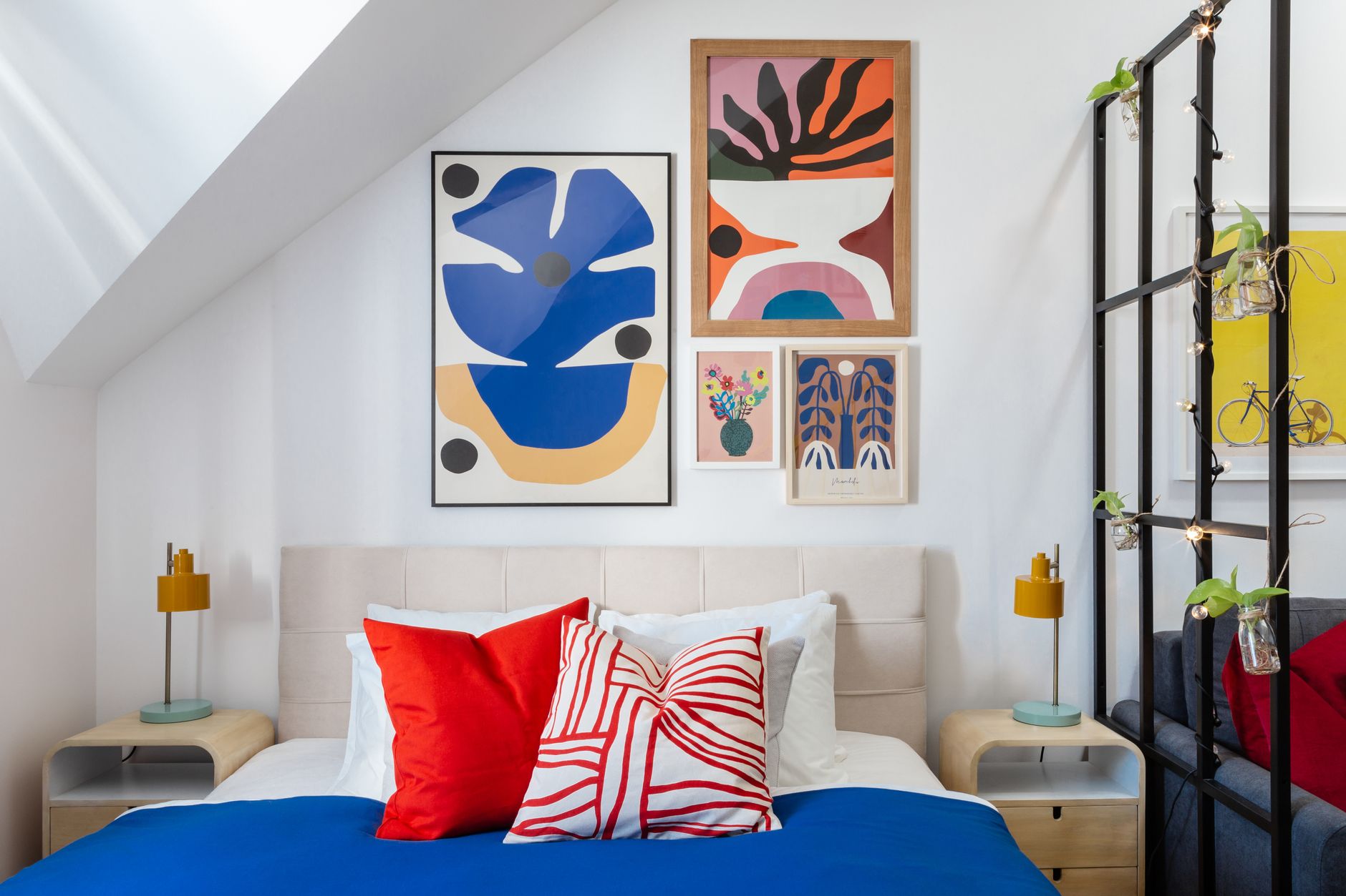 Artwork hanging above a bed in a bedroom