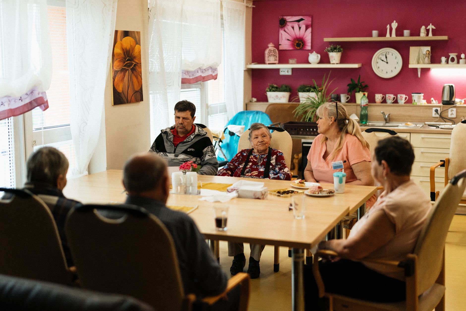 Older adults sitting around a dining table