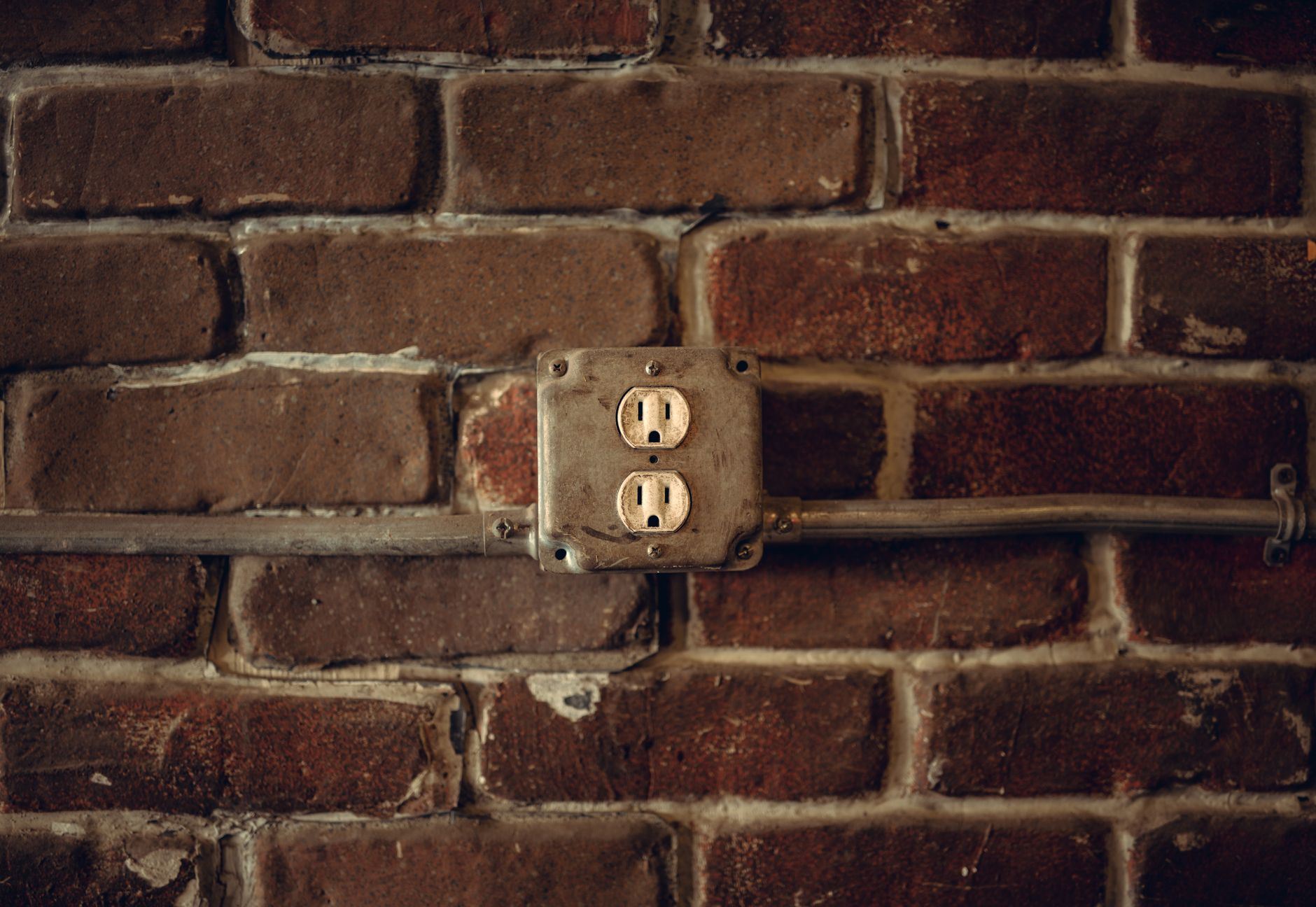 An outlet on a brick wall