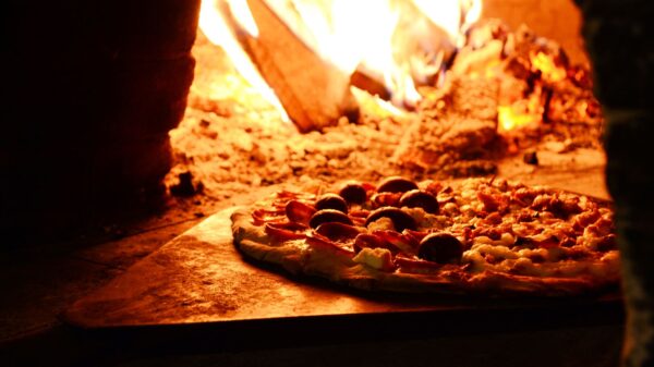 Best pizza oven: a pizza baking in an outdoor oven