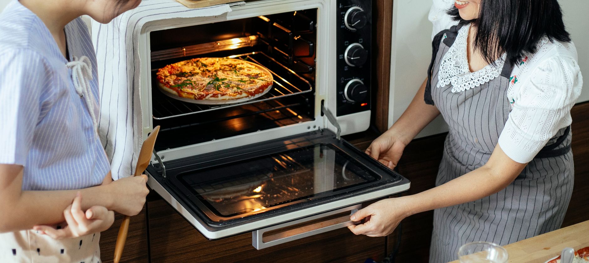 A pizza baking inside a home oven
