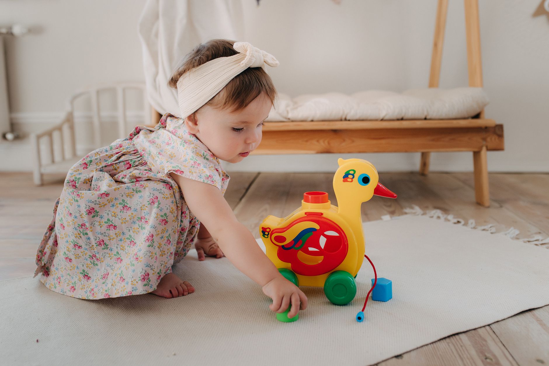 Soft baby toys laid out on a floor mat