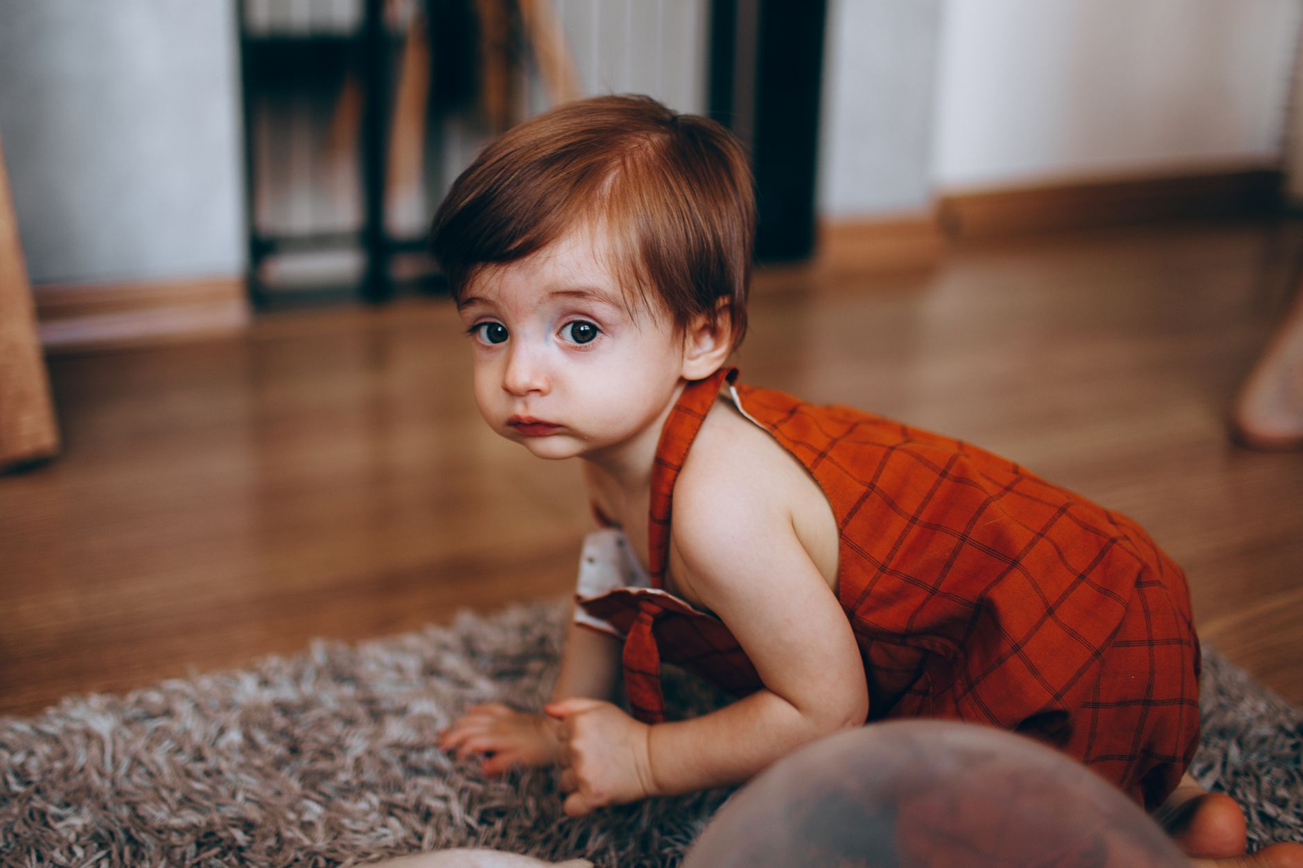 A baby crawling on a soft floor
