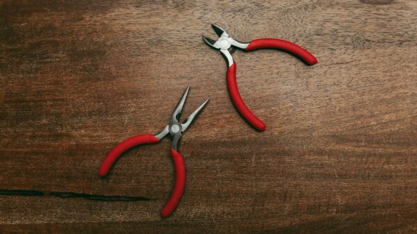 Best pliers set: several pairs of pliers laid out on a wooden work surface