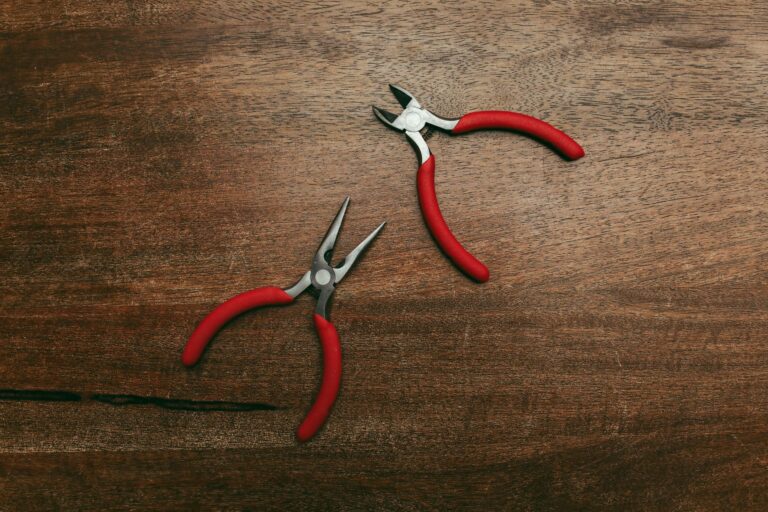 Best pliers set: several pairs of pliers laid out on a wooden work surface