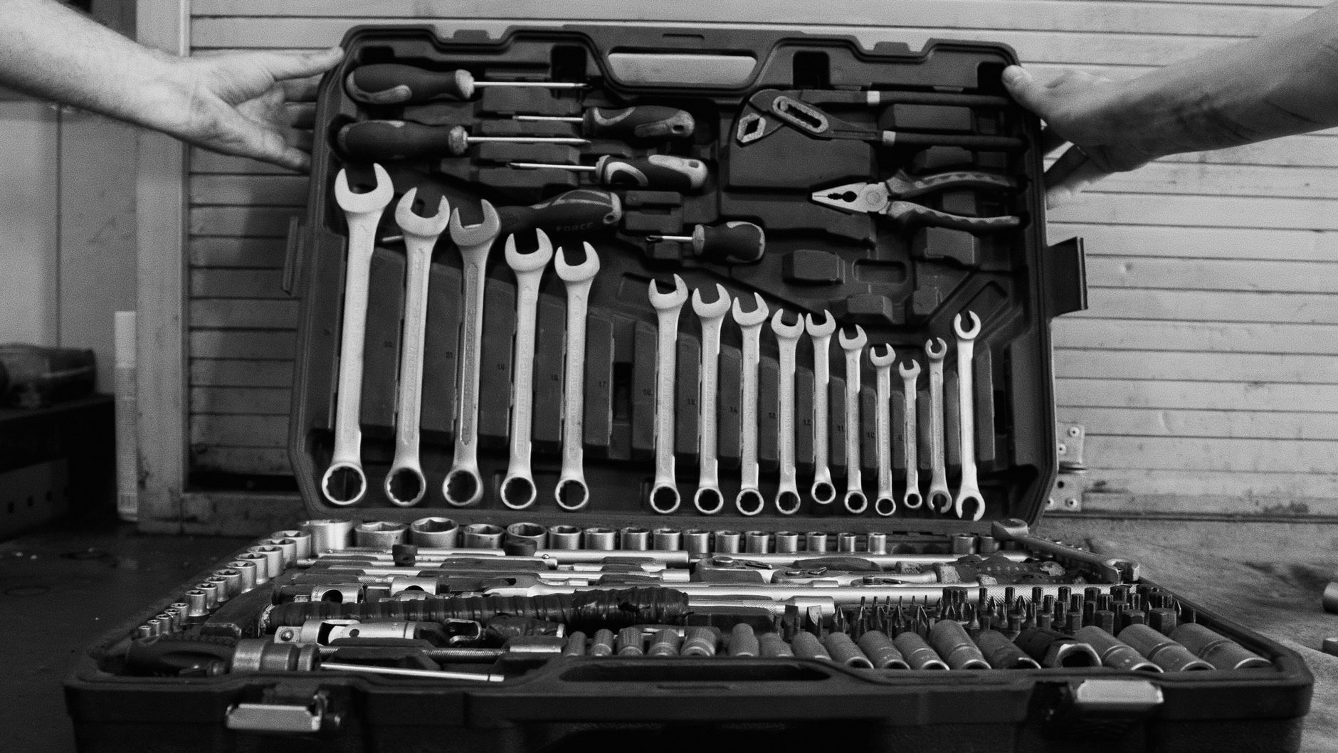 An open toolbox holding hand tools