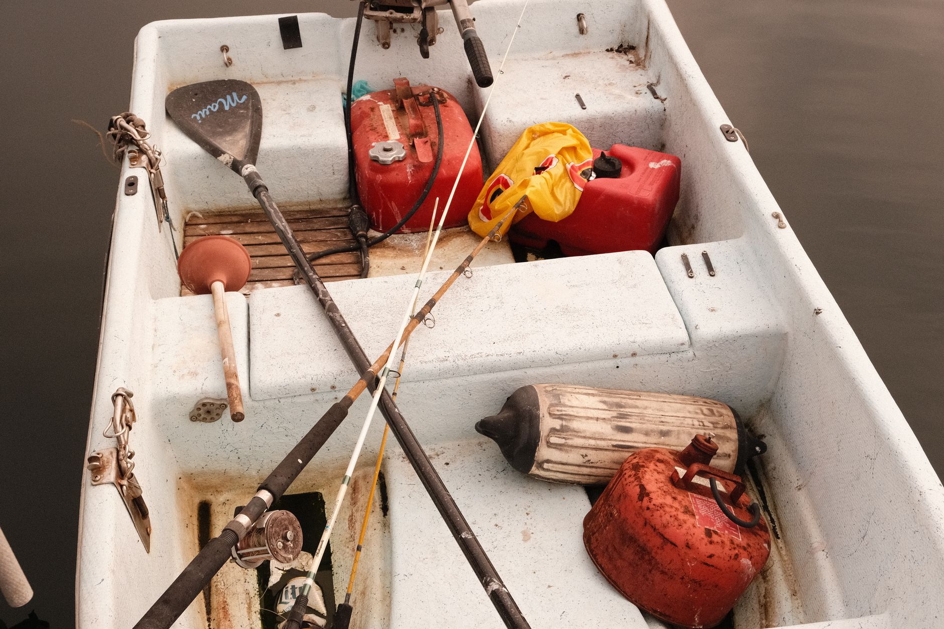 Fishing rods and gas cans in a small boat