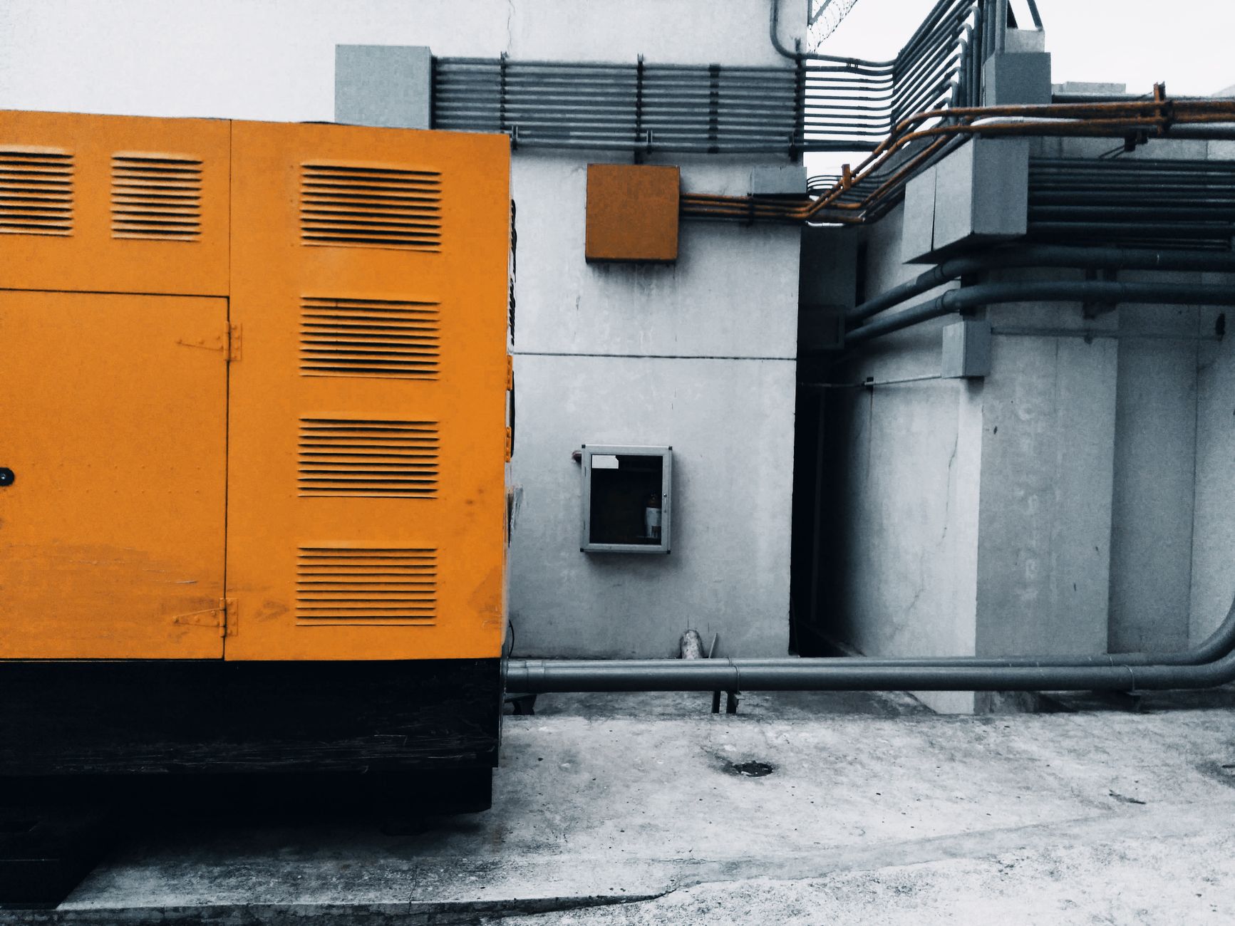 A large standby generator beside a building