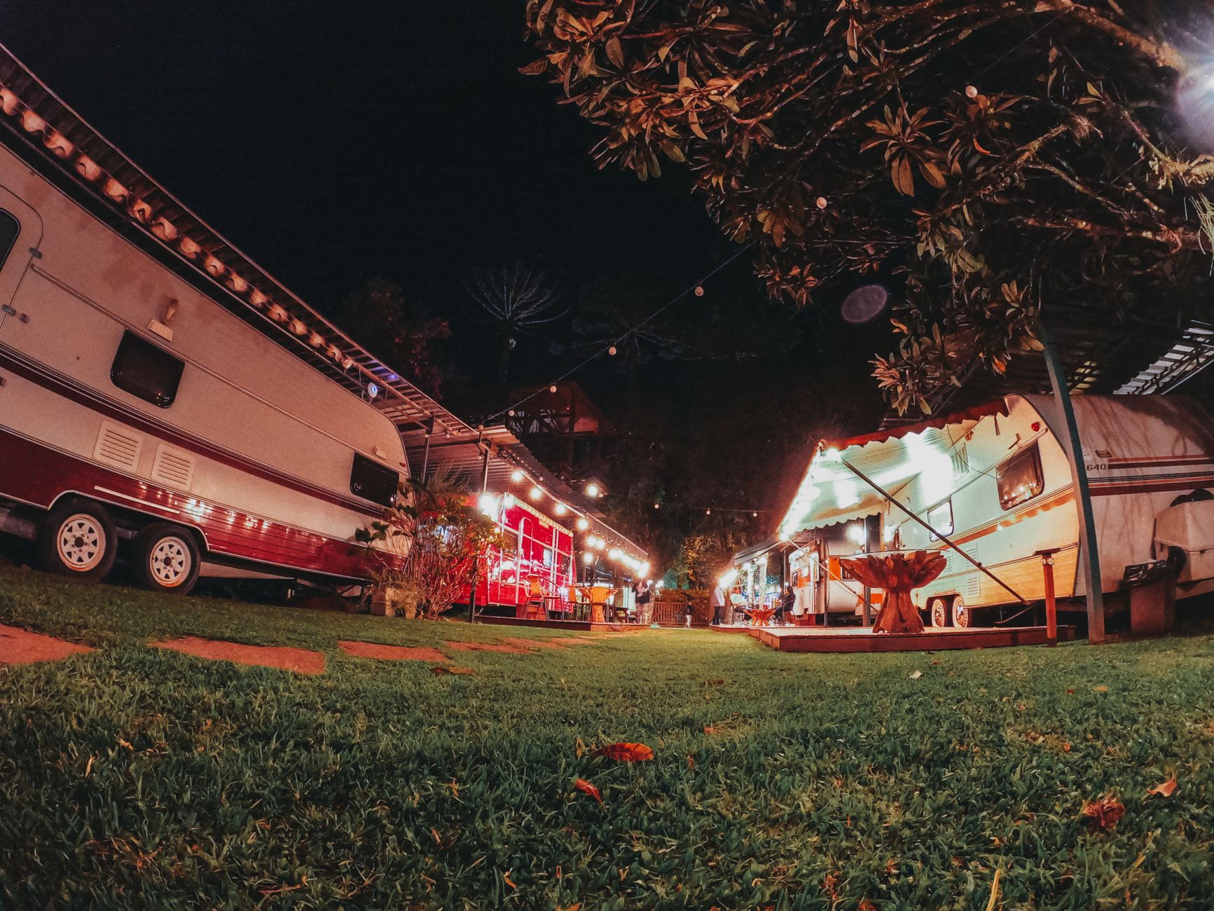 Camper trailers lit up at night