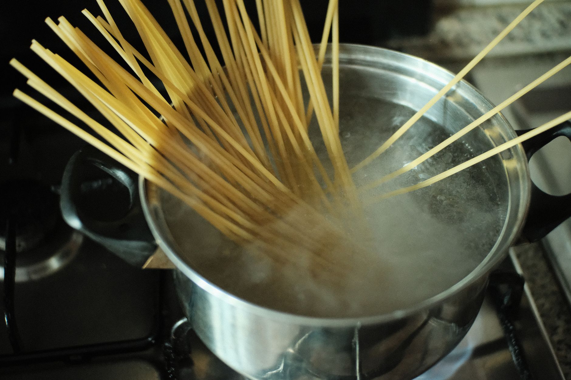 Spaghetti going into boiling water