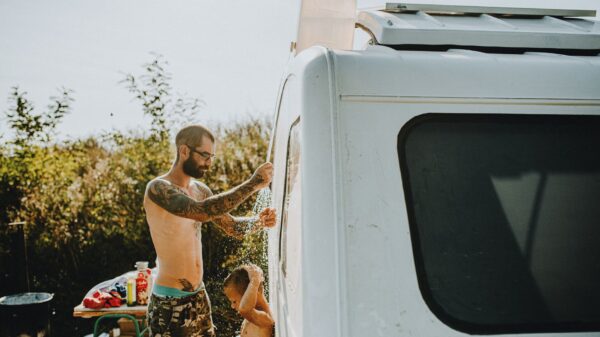 Best portable propane water heater: showering beside a camper van