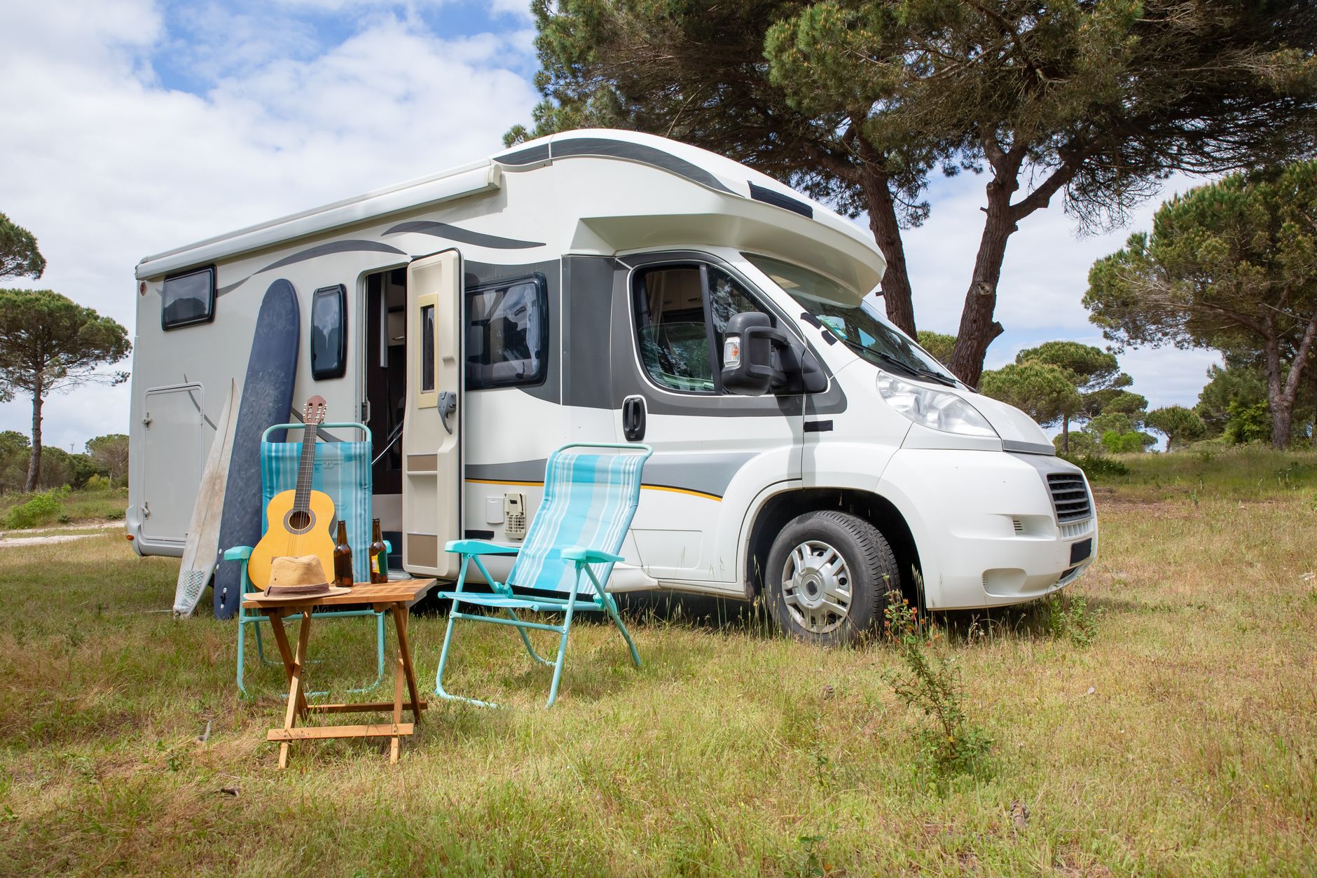 A motorhome with camp chairs