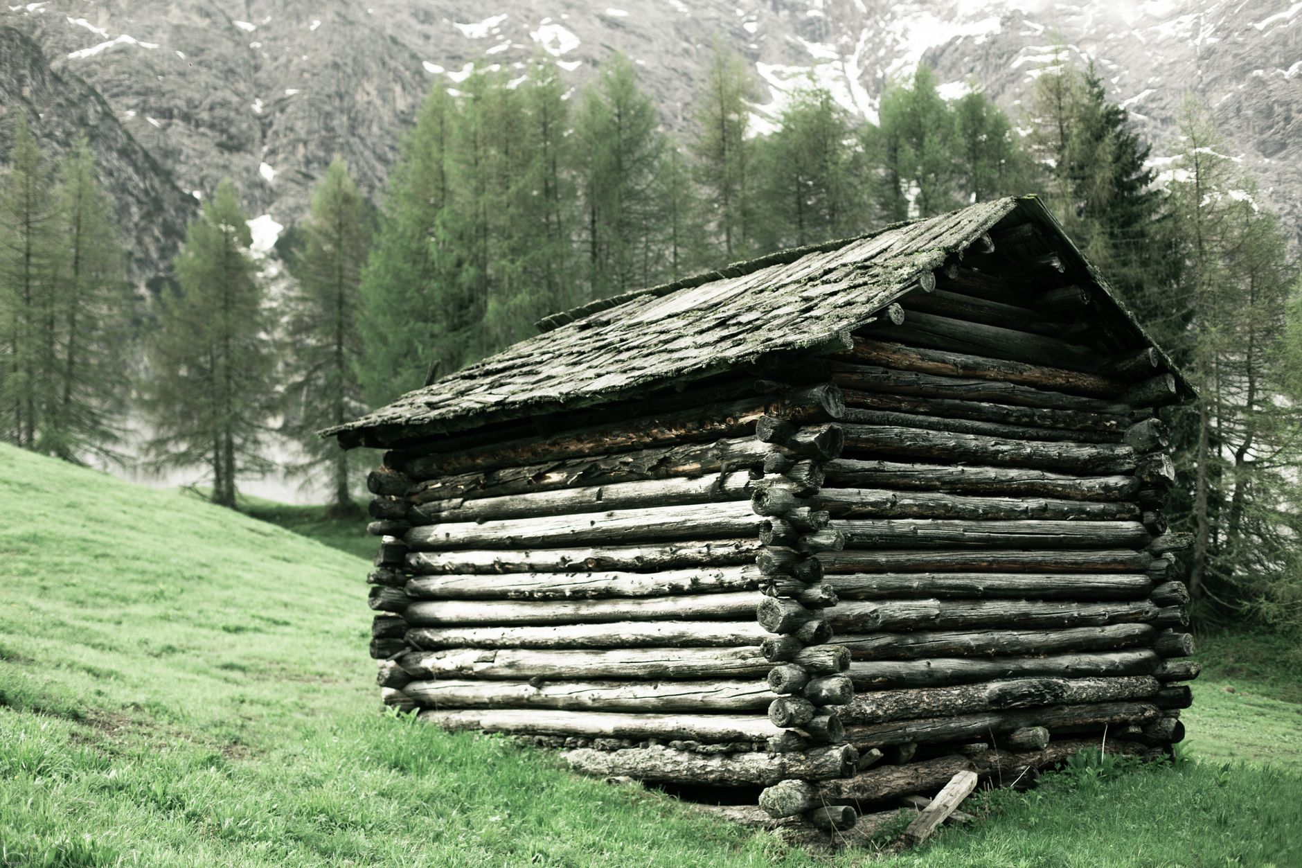 A log cabin on a mountain slope