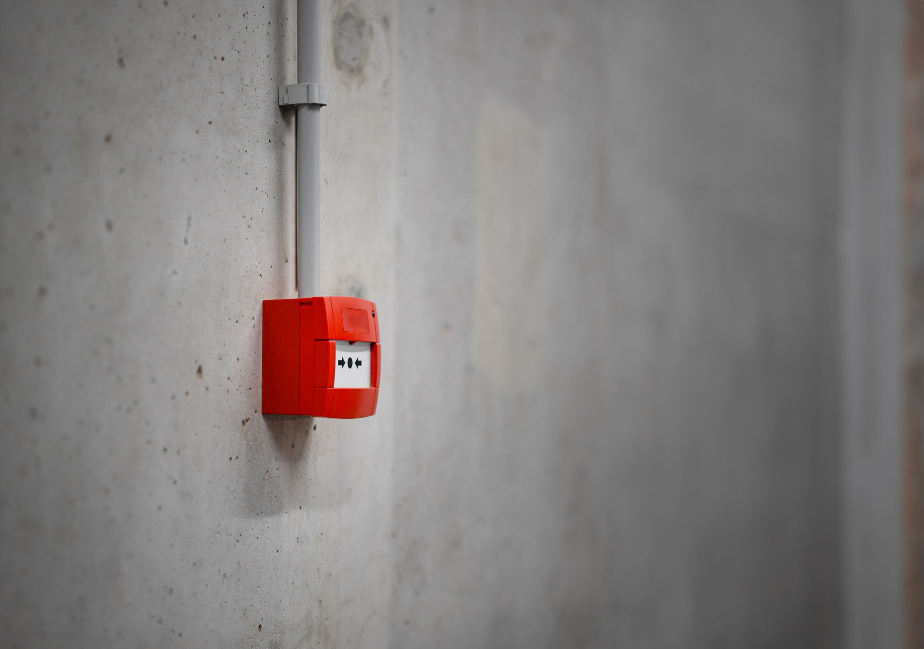A fire alarm pull station on a wall