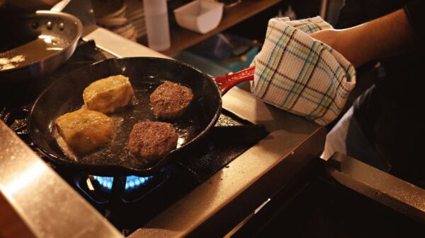 Best pot holders: a cook holding a hot pan with a pot holder