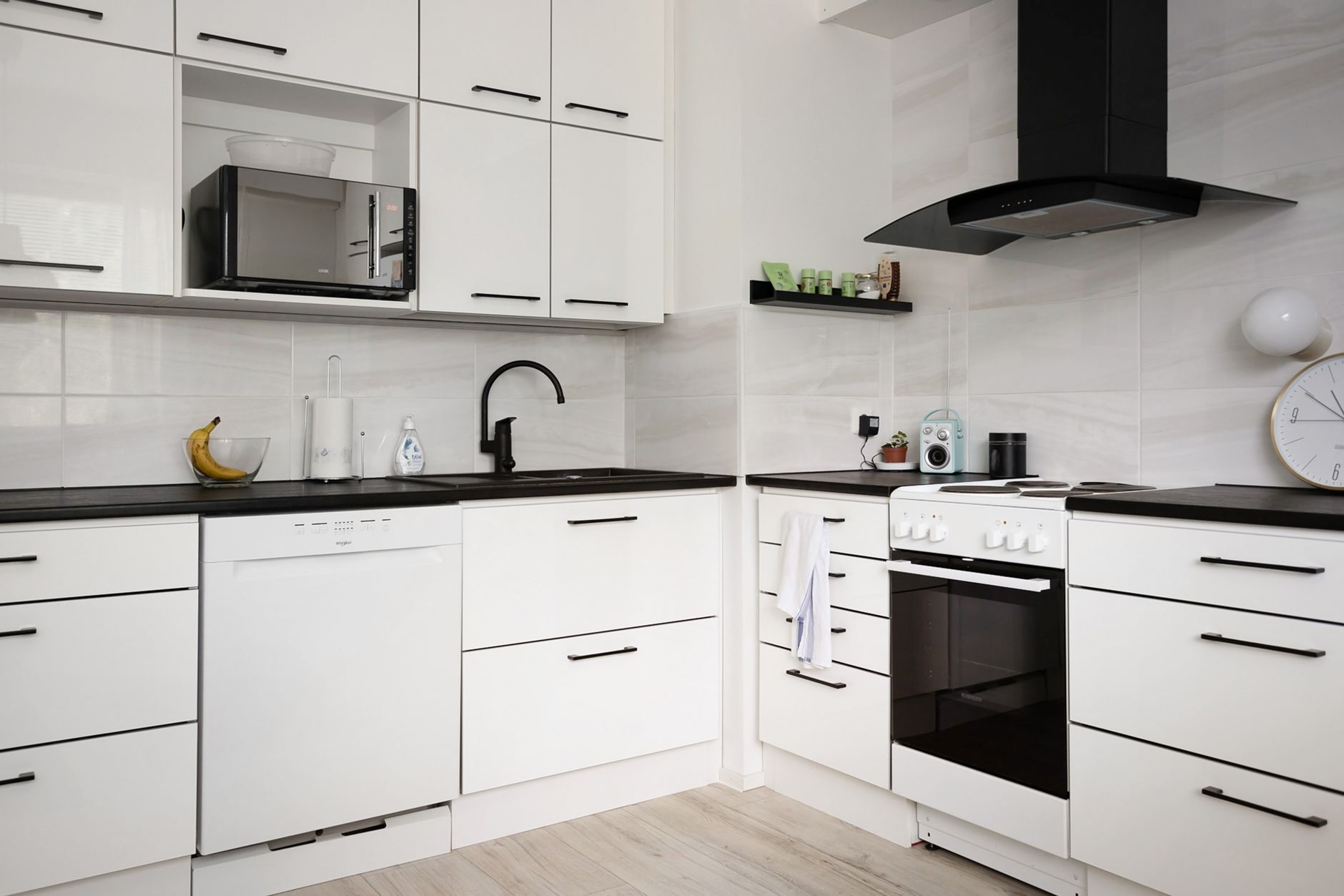 A white kitchen with a range hood and oven