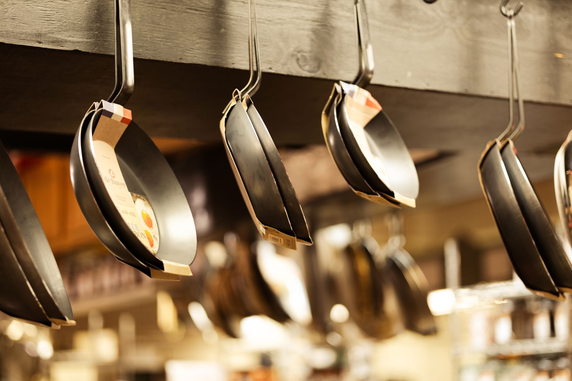 Frying pans hanging from a rack