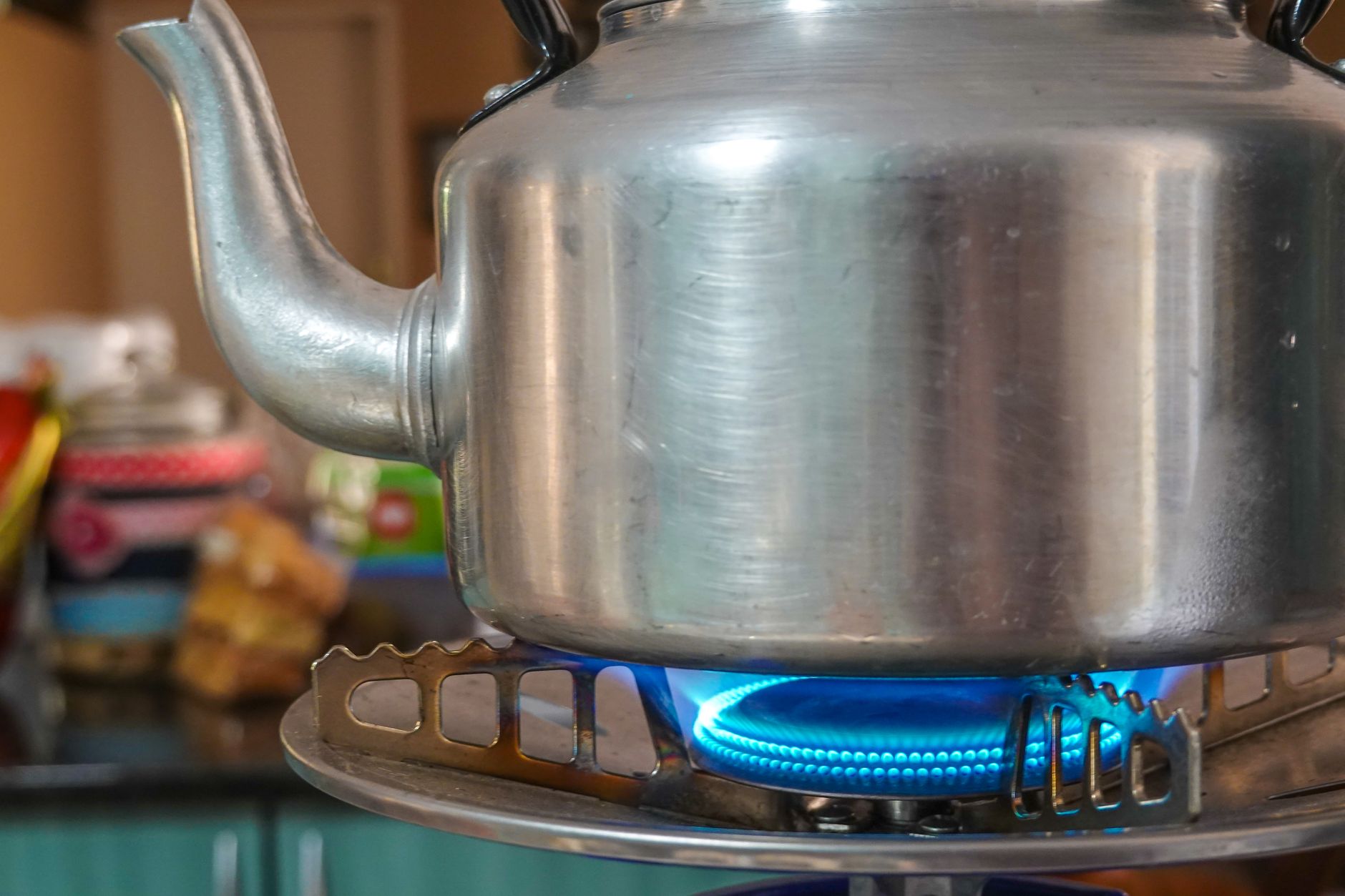 A kettle heating on a stove burner