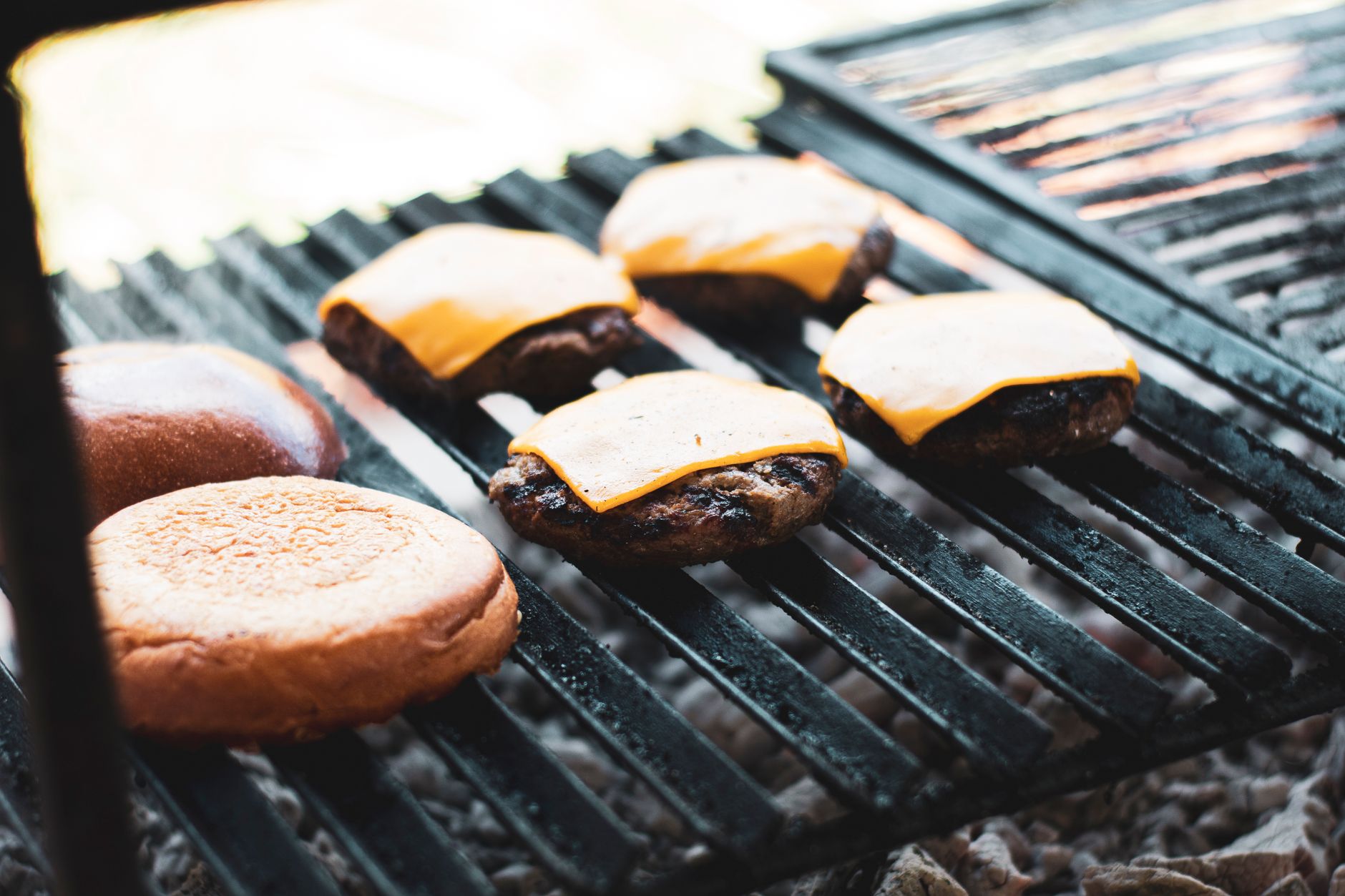 Cheeseburgers cooking on a grill